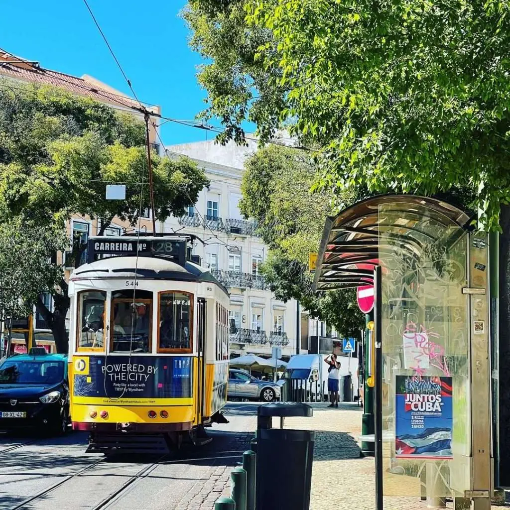Tram 28 travelling down a road from Graca, Lisbon